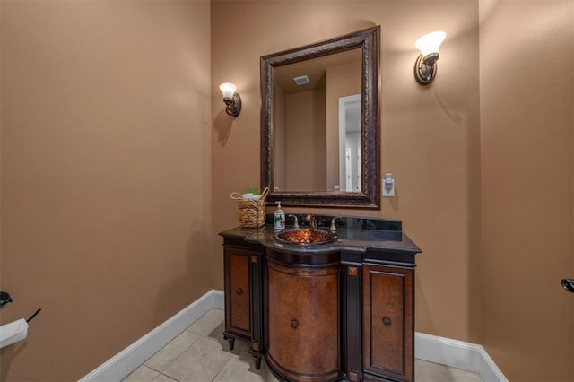 bathroom featuring tile patterned flooring, vanity, and baseboards