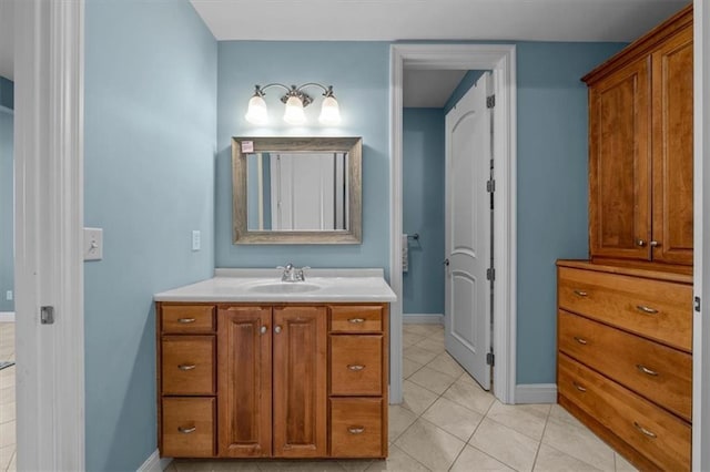 bathroom with tile patterned flooring, vanity, and baseboards