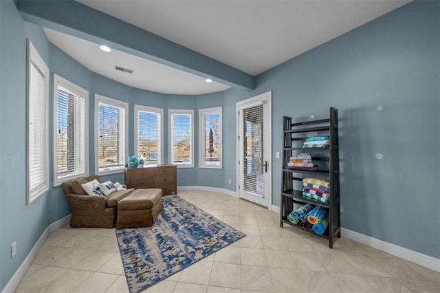 living area with tile patterned flooring, visible vents, recessed lighting, and baseboards