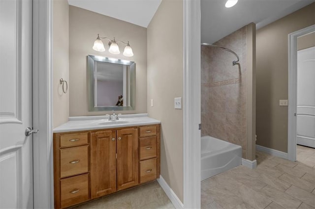 bathroom with vanity, shower / tub combination, and baseboards