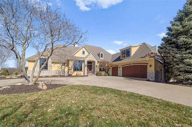 view of front of home with an attached garage, stucco siding, concrete driveway, a front lawn, and stone siding