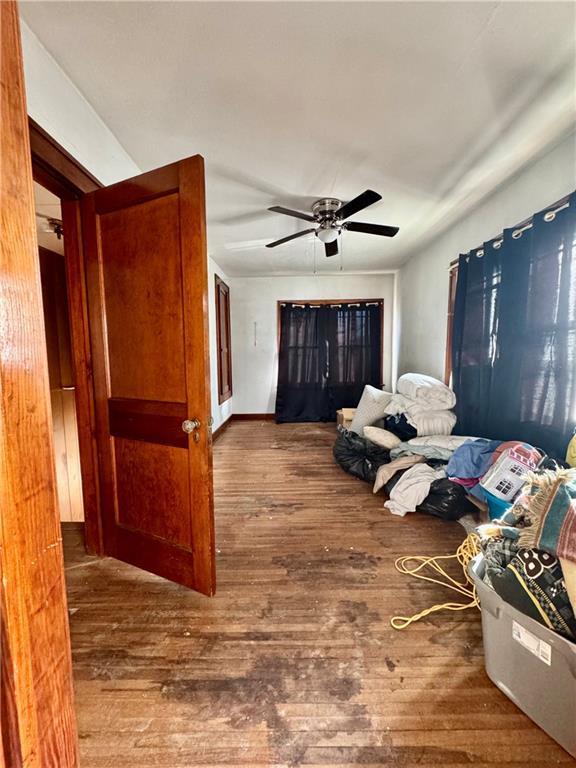 bedroom featuring dark hardwood / wood-style flooring and ceiling fan