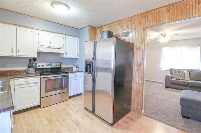 kitchen with white cabinetry, stainless steel appliances, a textured ceiling, and light wood-type flooring