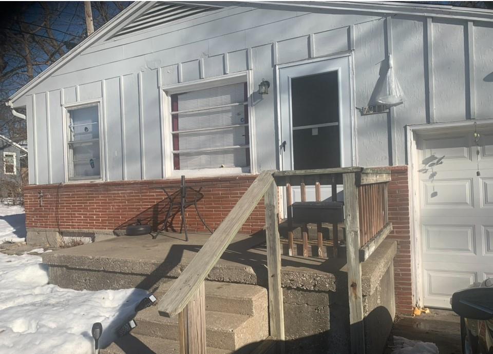 doorway to property with a garage