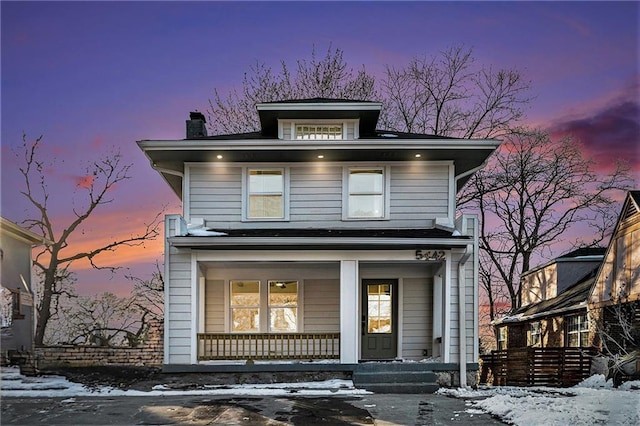 american foursquare style home with a porch