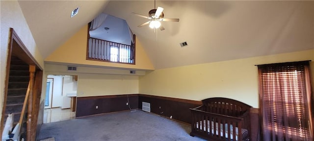 carpeted bedroom featuring high vaulted ceiling