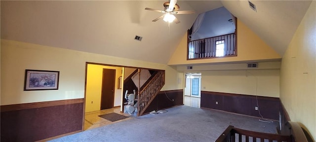 carpeted living room featuring ceiling fan and high vaulted ceiling