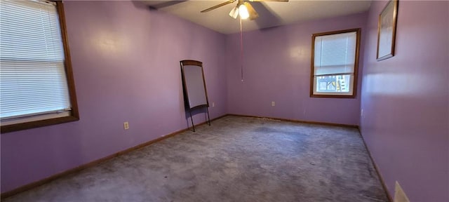 carpeted spare room with ceiling fan