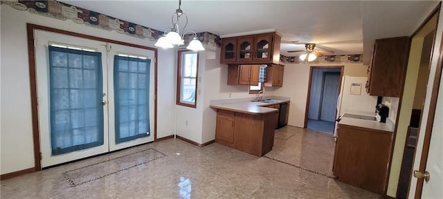 kitchen featuring french doors, sink, kitchen peninsula, pendant lighting, and ceiling fan