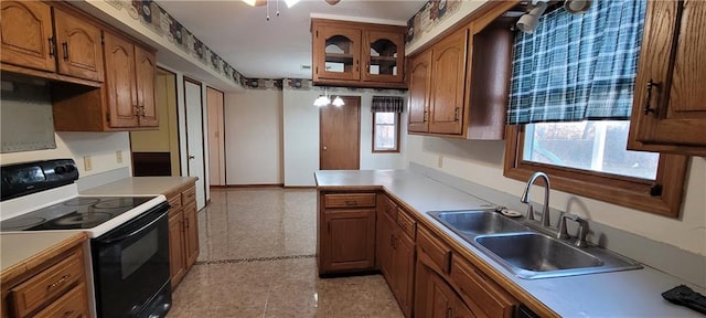 kitchen with sink, electric range, and ceiling fan