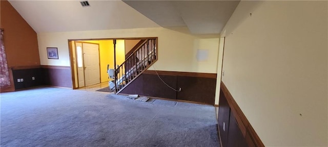 stairs with lofted ceiling and carpet