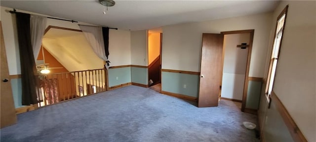 unfurnished room featuring ceiling fan and carpet floors