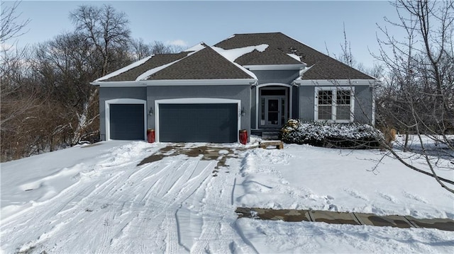 ranch-style house featuring an attached garage and stucco siding