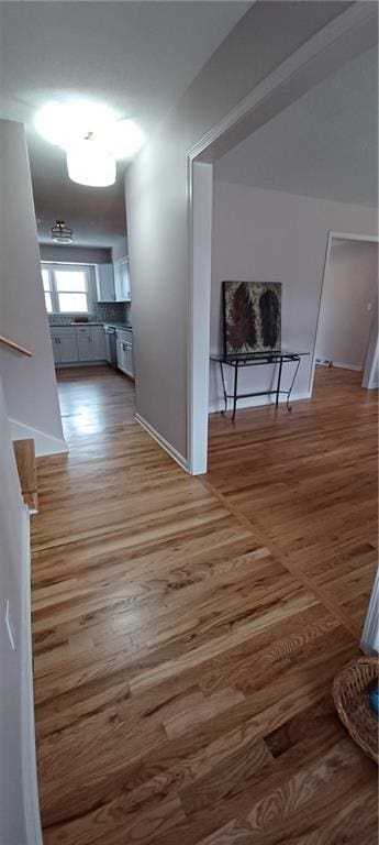 corridor with hardwood / wood-style floors