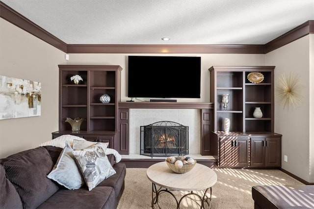 living room with ornamental molding, carpet, baseboards, and a tiled fireplace