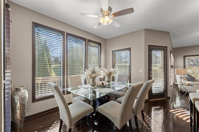 dining area with a ceiling fan, baseboards, and wood finished floors