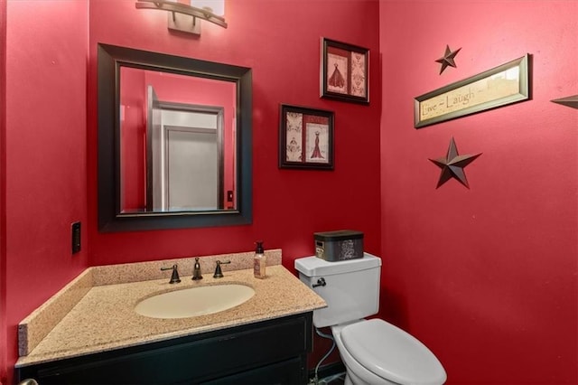 bathroom featuring toilet and vanity