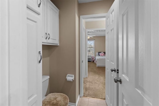 bathroom featuring baseboards, toilet, and tile patterned floors