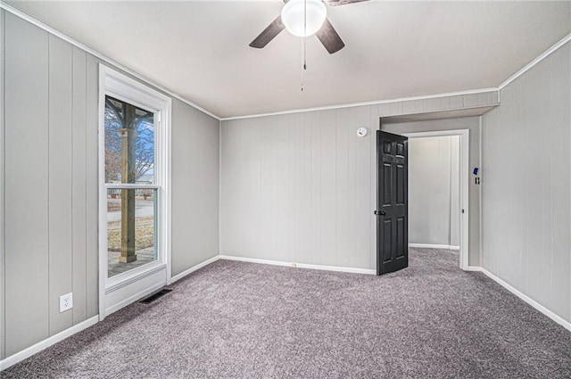 spare room featuring ornamental molding, carpet flooring, and ceiling fan