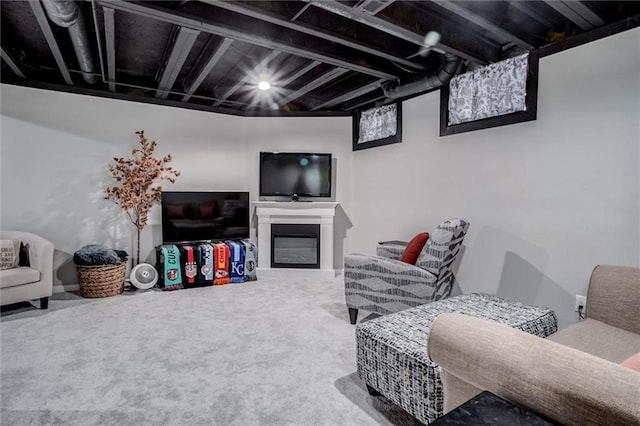 living area featuring carpet flooring and a glass covered fireplace