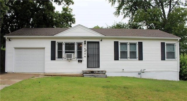 view of front of home featuring a garage, a front yard, and cooling unit