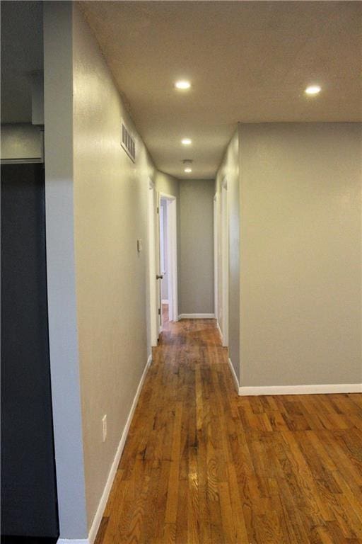 hallway with hardwood / wood-style floors