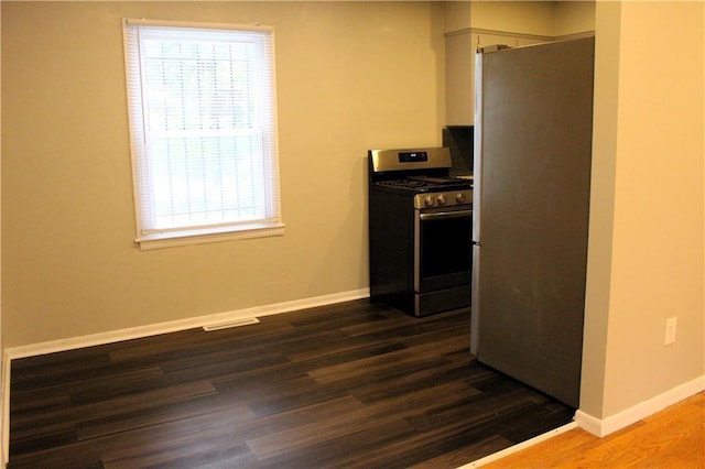 kitchen featuring stainless steel appliances and dark wood-type flooring