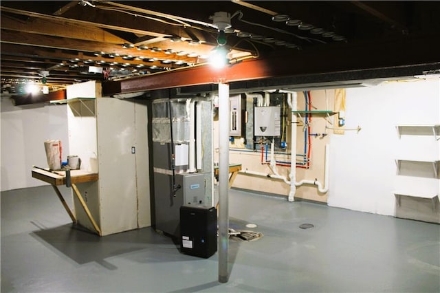 basement featuring water heater and heating unit