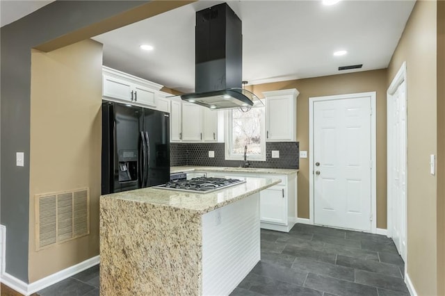 kitchen featuring white cabinetry, a center island, island exhaust hood, black refrigerator with ice dispenser, and stainless steel gas stovetop