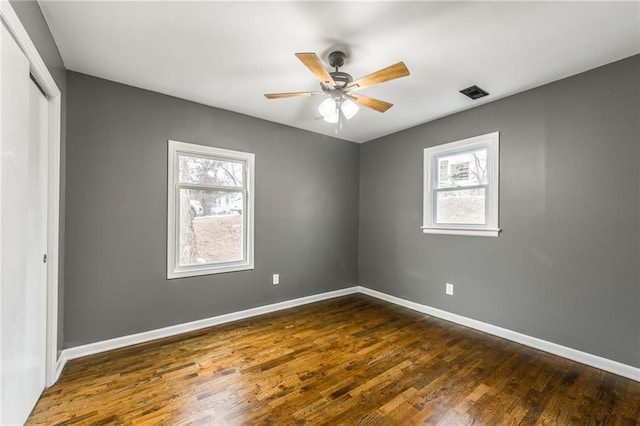 unfurnished room featuring dark hardwood / wood-style floors and ceiling fan