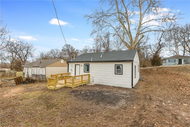 back of house featuring a wooden deck