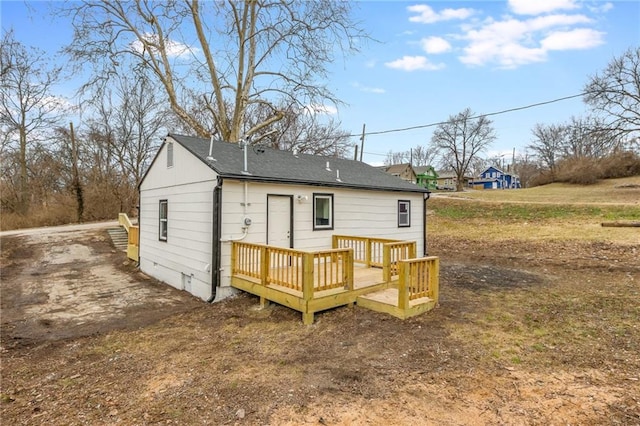 back of property with a wooden deck