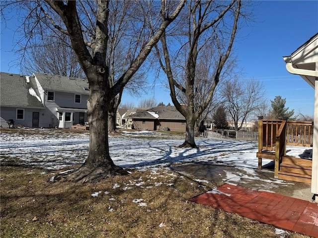 yard covered in snow featuring a wooden deck