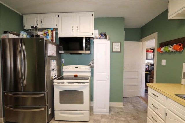 kitchen with appliances with stainless steel finishes and white cabinets