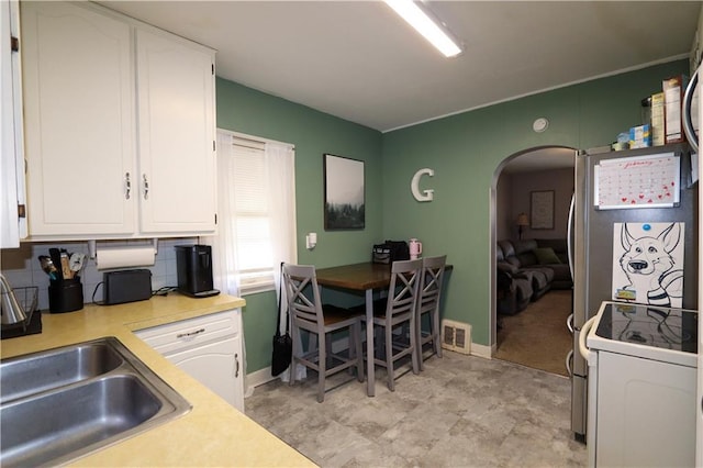 kitchen featuring white cabinetry, sink, and white electric range