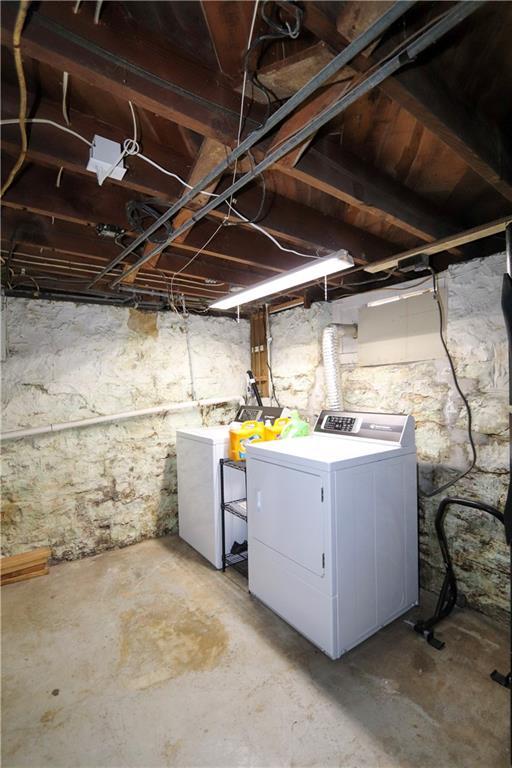 basement with fridge and washing machine and dryer