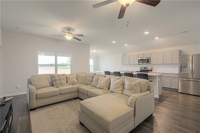 living room with wood-type flooring and ceiling fan