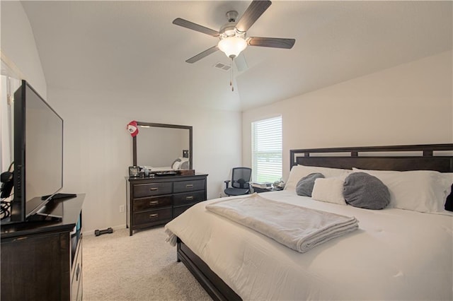 bedroom with lofted ceiling, light colored carpet, and ceiling fan