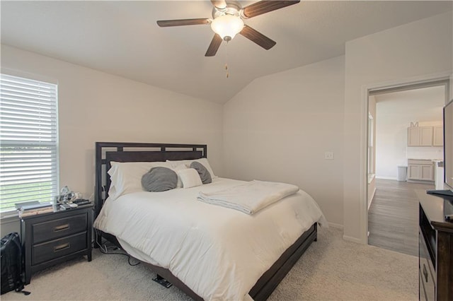 carpeted bedroom with vaulted ceiling and ceiling fan