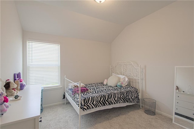 carpeted bedroom with lofted ceiling