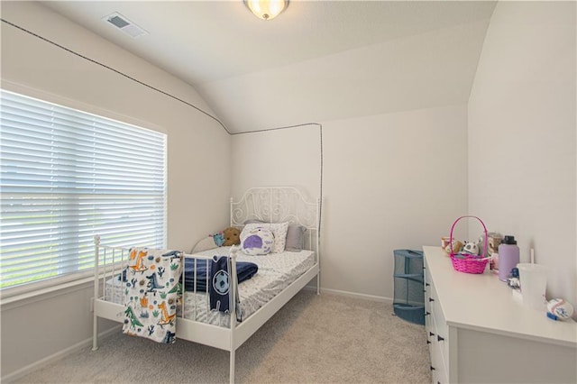 carpeted bedroom with lofted ceiling