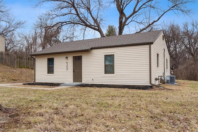 view of front of property with central AC unit and a front lawn