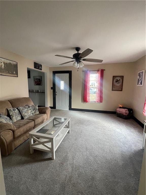 carpeted living room with ceiling fan