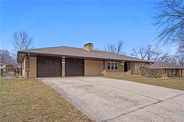 ranch-style home featuring a garage and a front lawn