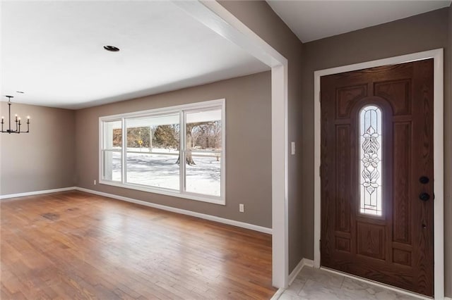 foyer with a chandelier and light hardwood / wood-style flooring