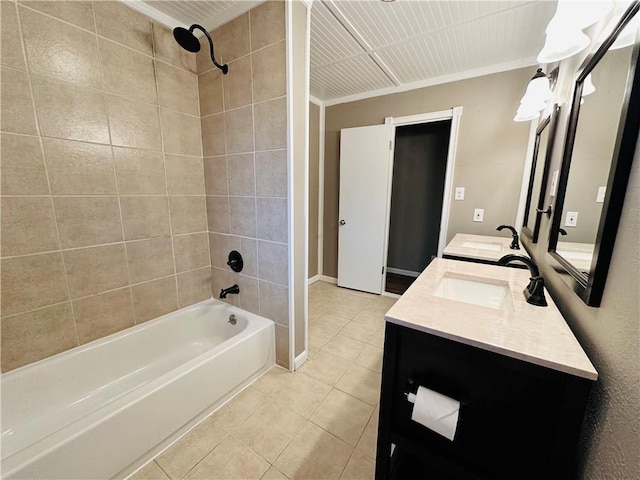 bathroom featuring ornamental molding, tile patterned floors, tiled shower / bath combo, and vanity