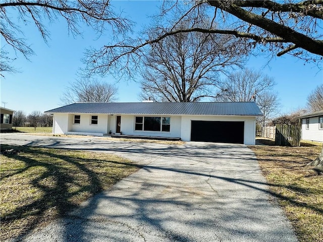 305 N Free King Hwy, Pittsburg, KS 66762 - ranch-style home with driveway, a garage, metal roof, and stucco siding