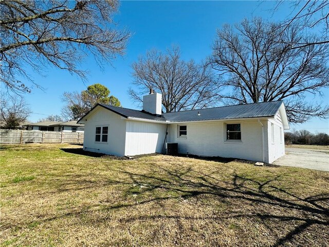 305 N Free King Hwy, Pittsburg, KS 66762 - rear view of house featuring a chimney, metal roof, and brick siding