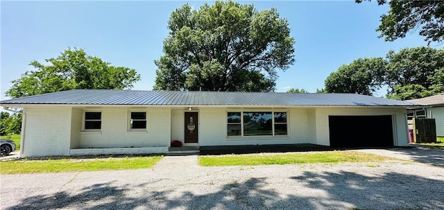 305 N Free King Hwy, Pittsburg, KS 66762 - ranch-style home featuring a garage, metal roof, driveway, and brick siding