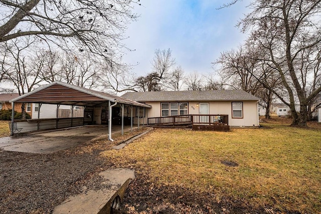 rear view of house featuring a carport, a wooden deck, and a yard